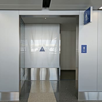 Custom glass wall-cladding on GeoLite Honeycomb Backer elevator at the United Airlines Terminal at Lax and etched on glass by Skyline Design, the industry-leading architectural glass manufacturer.