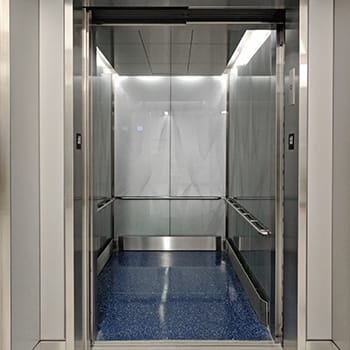 Custom glass wall-cladding on GeoLite Honeycomb Backer elevator at the United Airlines Terminal at Lax and etched on glass by Skyline Design, the industry-leading architectural glass manufacturer.