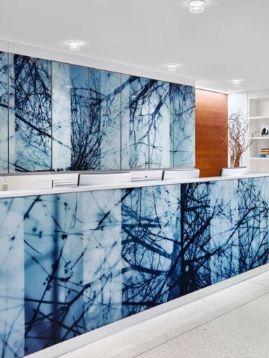 A piece of commericial glass artwork hung on the glass partition of Peter Cooper Village Stuyvesant Town by Skyline Design, the industry-leading architectural glass manufacturer.